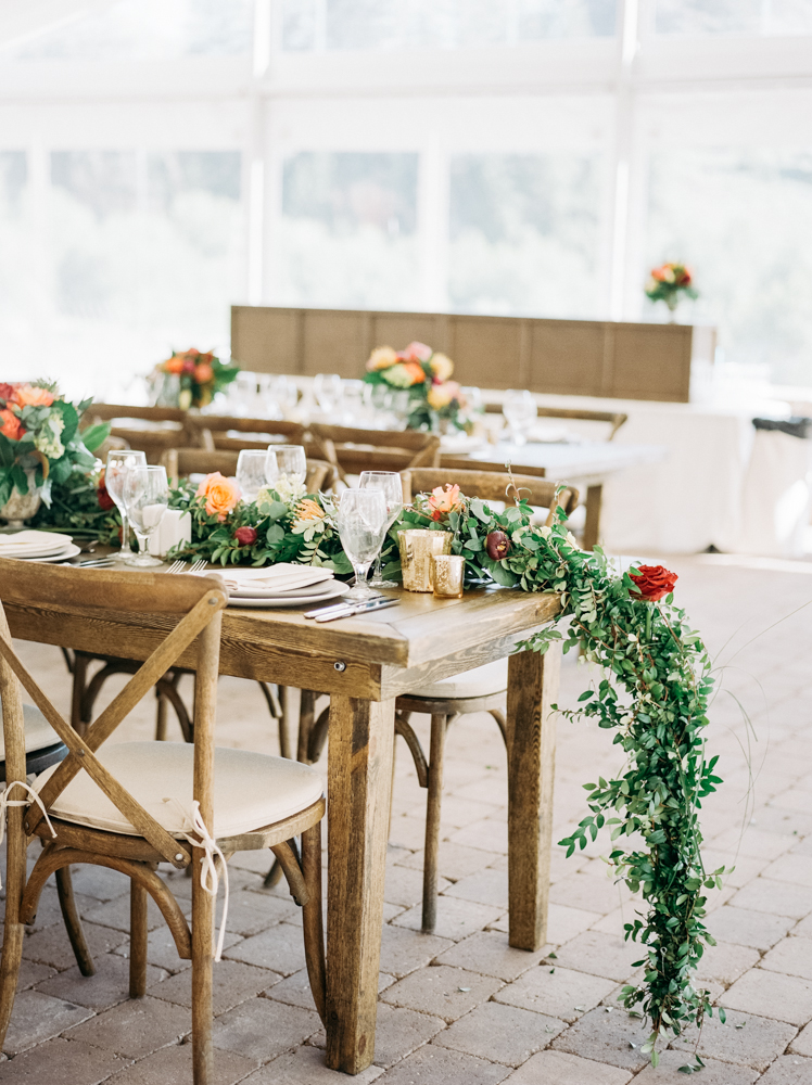 The head table is decorated with florals at the Trail Creek Cabin wedding.