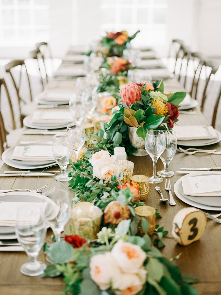 The head table is decorated with florals at the Trail Creek Cabin wedding.