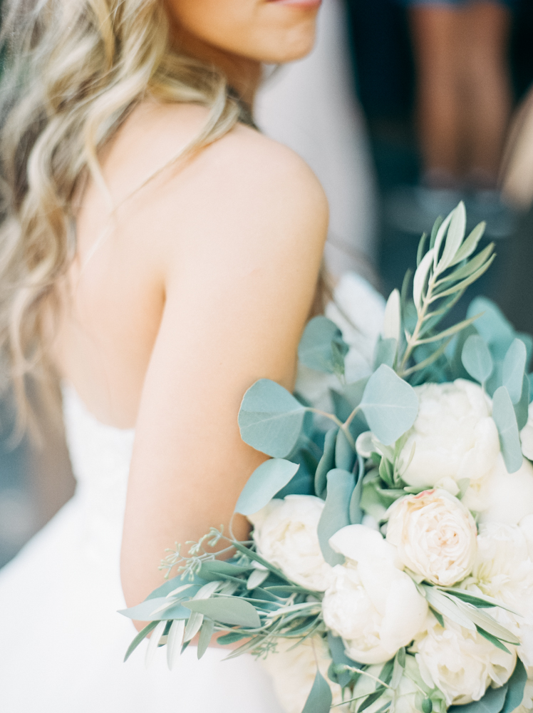 Bride holds a bouquet.