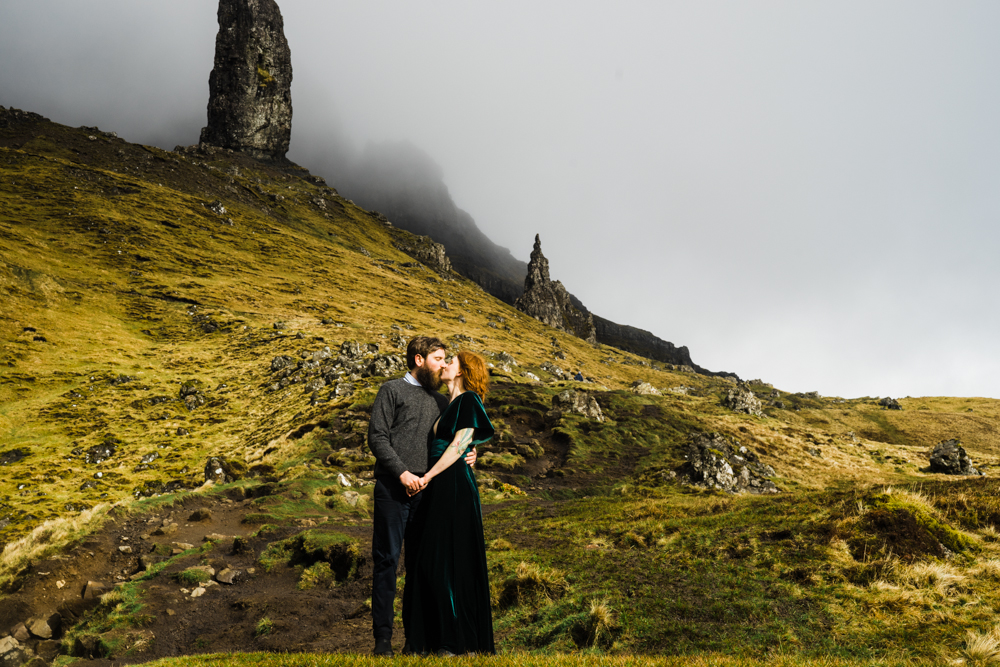 A couple kisses on a hillside during their Isle of Skye elopement.
